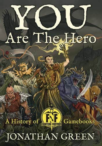 Cover of You Are The Hero by Jonathan Green. Features a group of fantasy characters, including a warrior, wizard, and creatures, in a dynamic battle scene. Text: A History of Fighting Fantasy Gamebooks with a circular emblem at the bottom center.