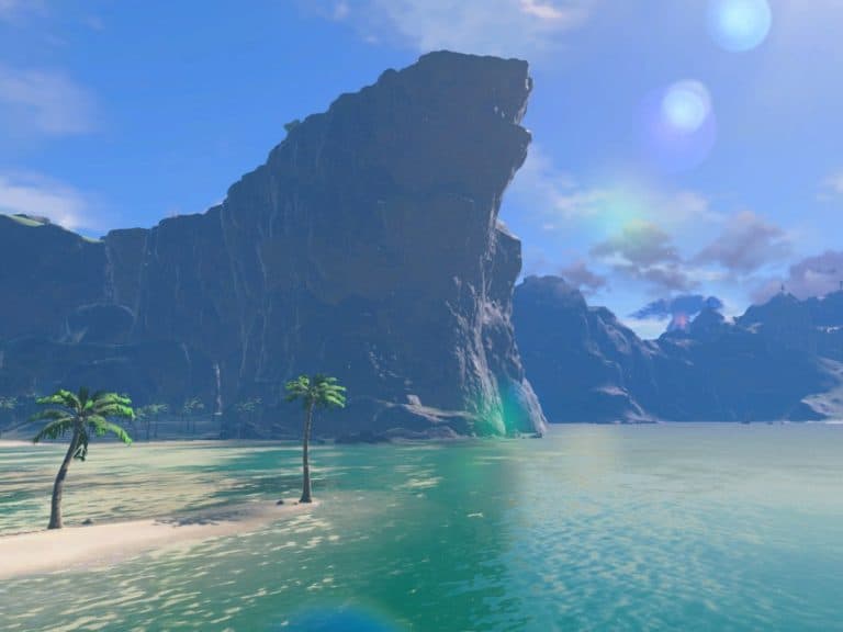A scenic view of a beach with two palm trees on sandy shores, overlooking calm teal waters. A large, rugged rock formation rises prominently against a clear blue sky with a couple of lens flares.